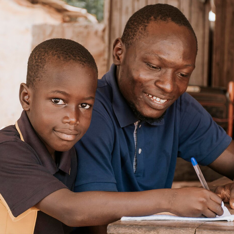 A man teaching a child
